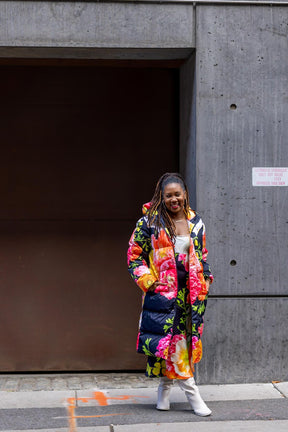 Black puffer coat with colorful florals, styled with floral slip dress and white boots, Dressed in Joy
