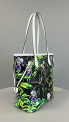 Tropical-themed bag with floral and leaf design on a marble surface