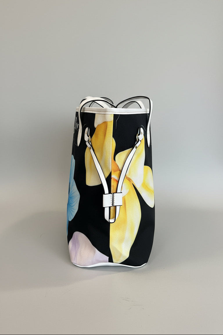 Black bag with yellow floral design on a marble surface