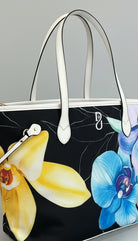 Floral-patterned handbag with yellow and blue flowers on a marble surface